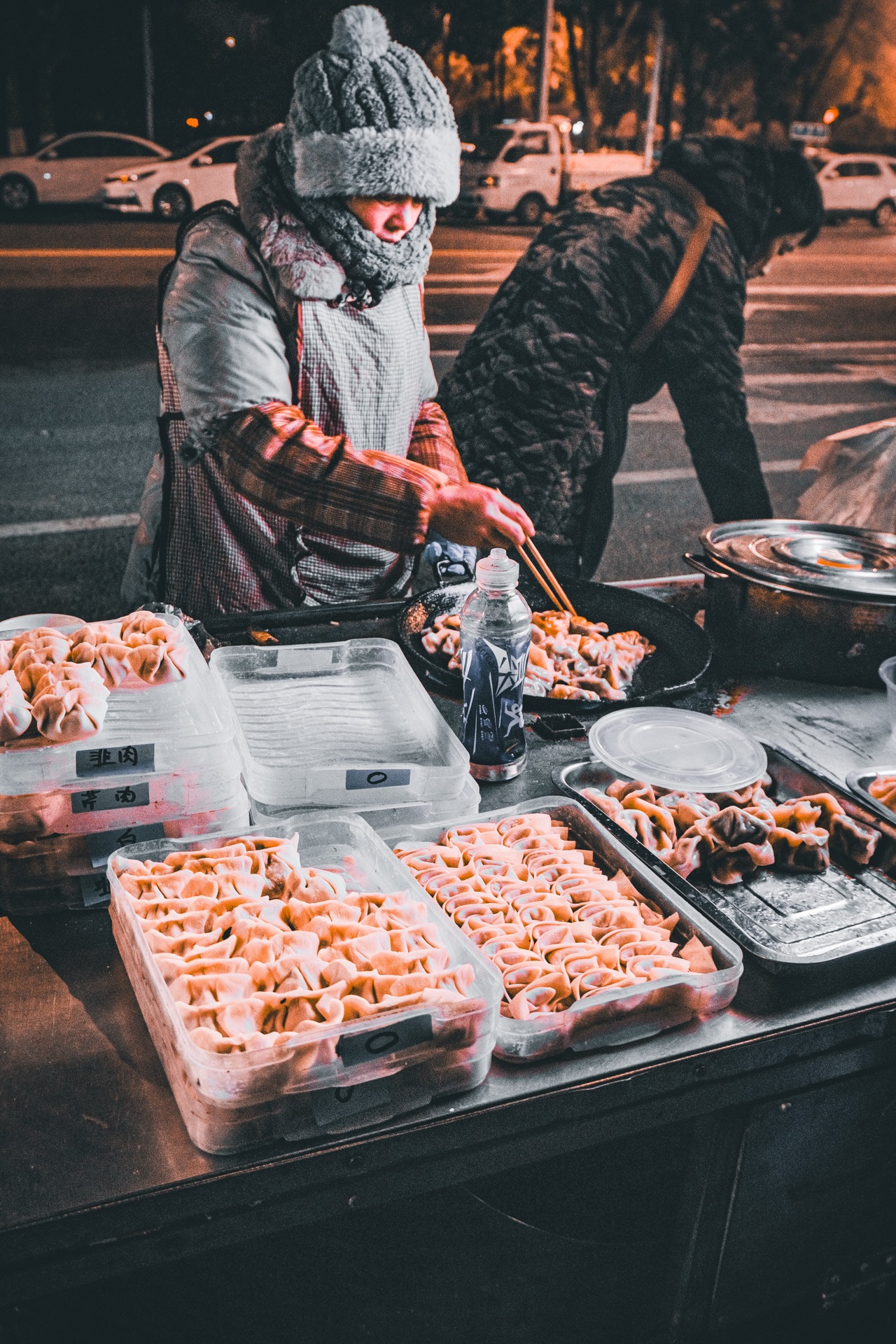 Street food vendor making dumplings at night