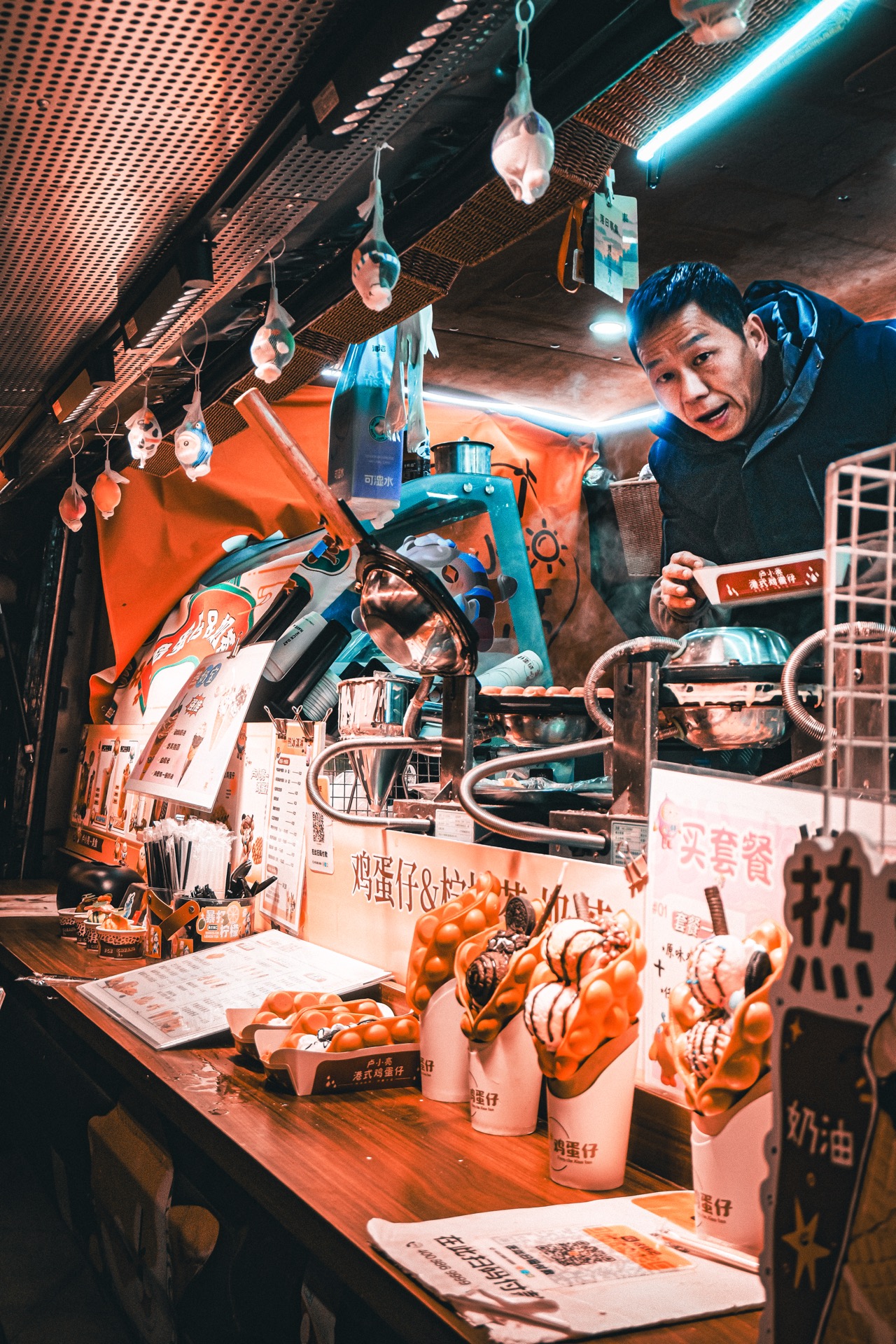 Energetic street food vendor at a night market
