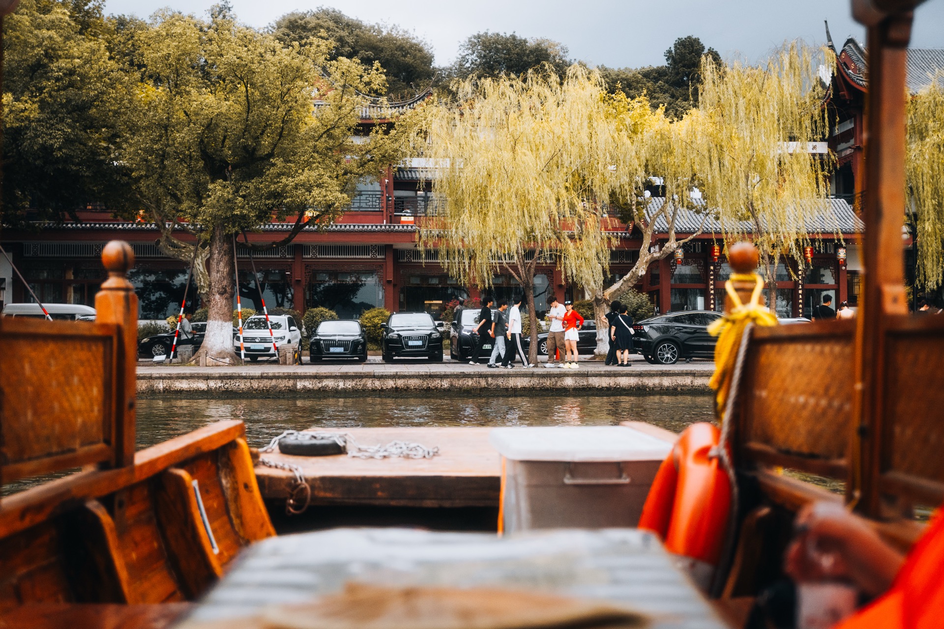 Wooden boat on a canal lined with willow trees, Suzhou