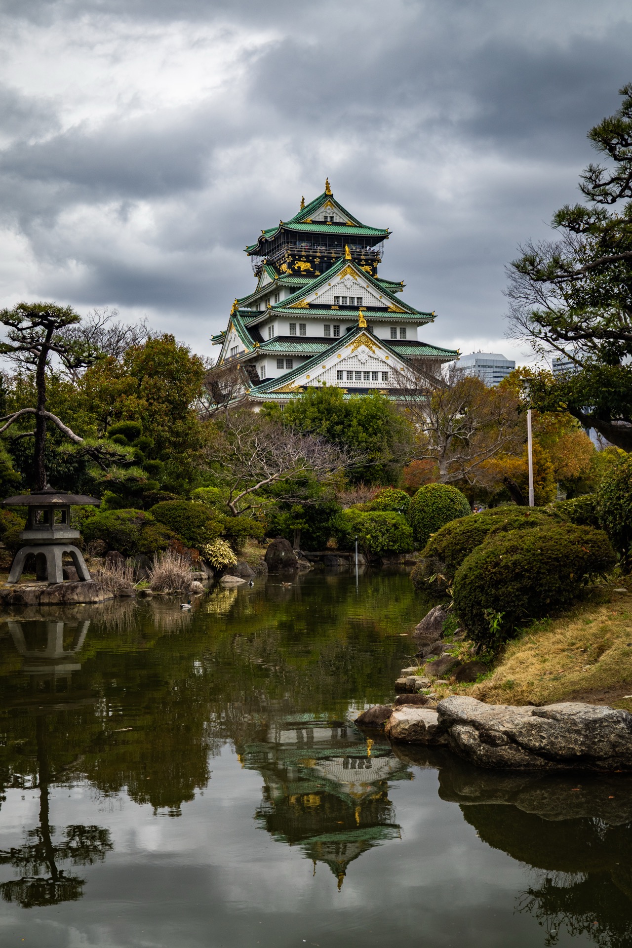 Osaka Castle reflected in garden pond