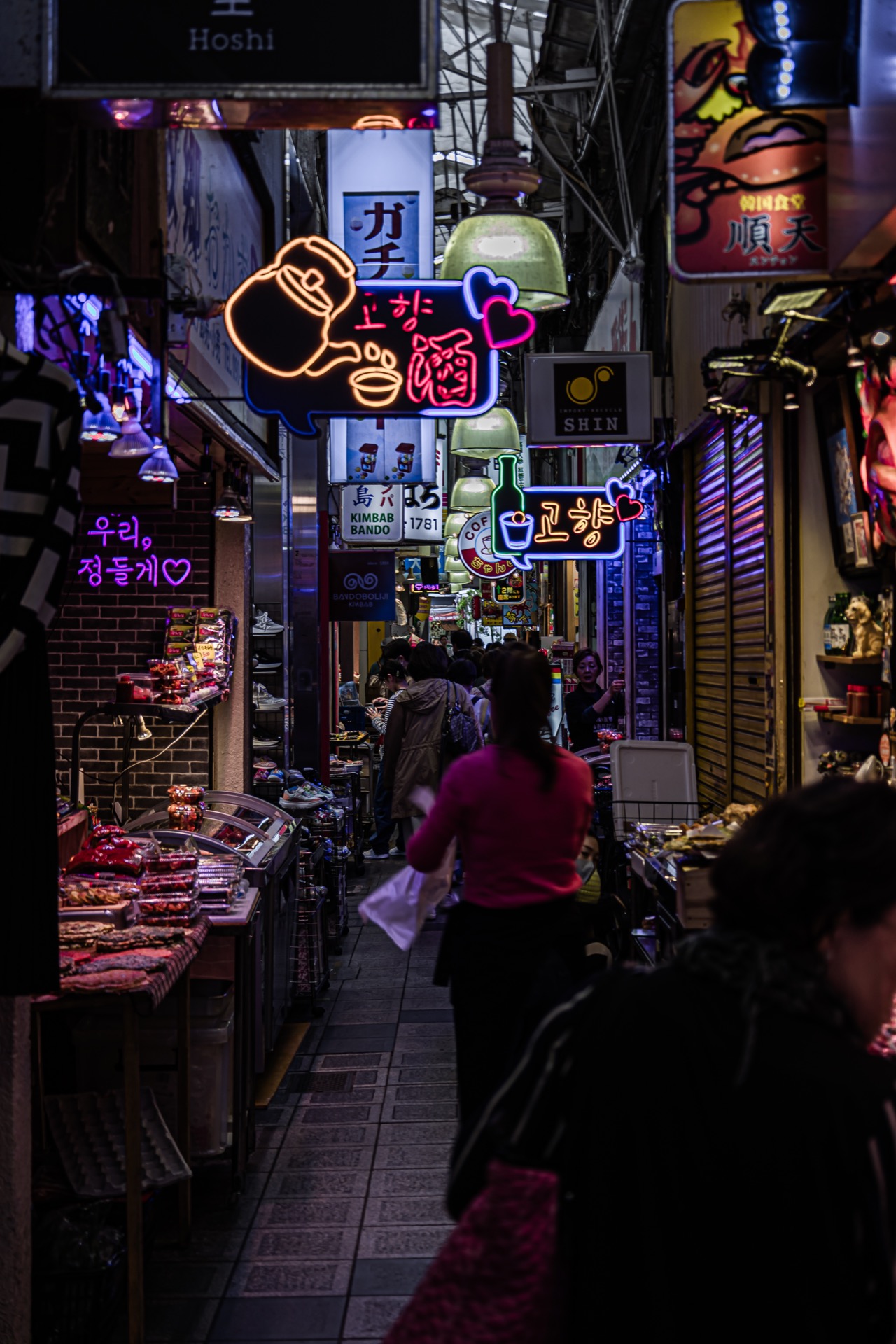 Neon-lit narrow alley at night