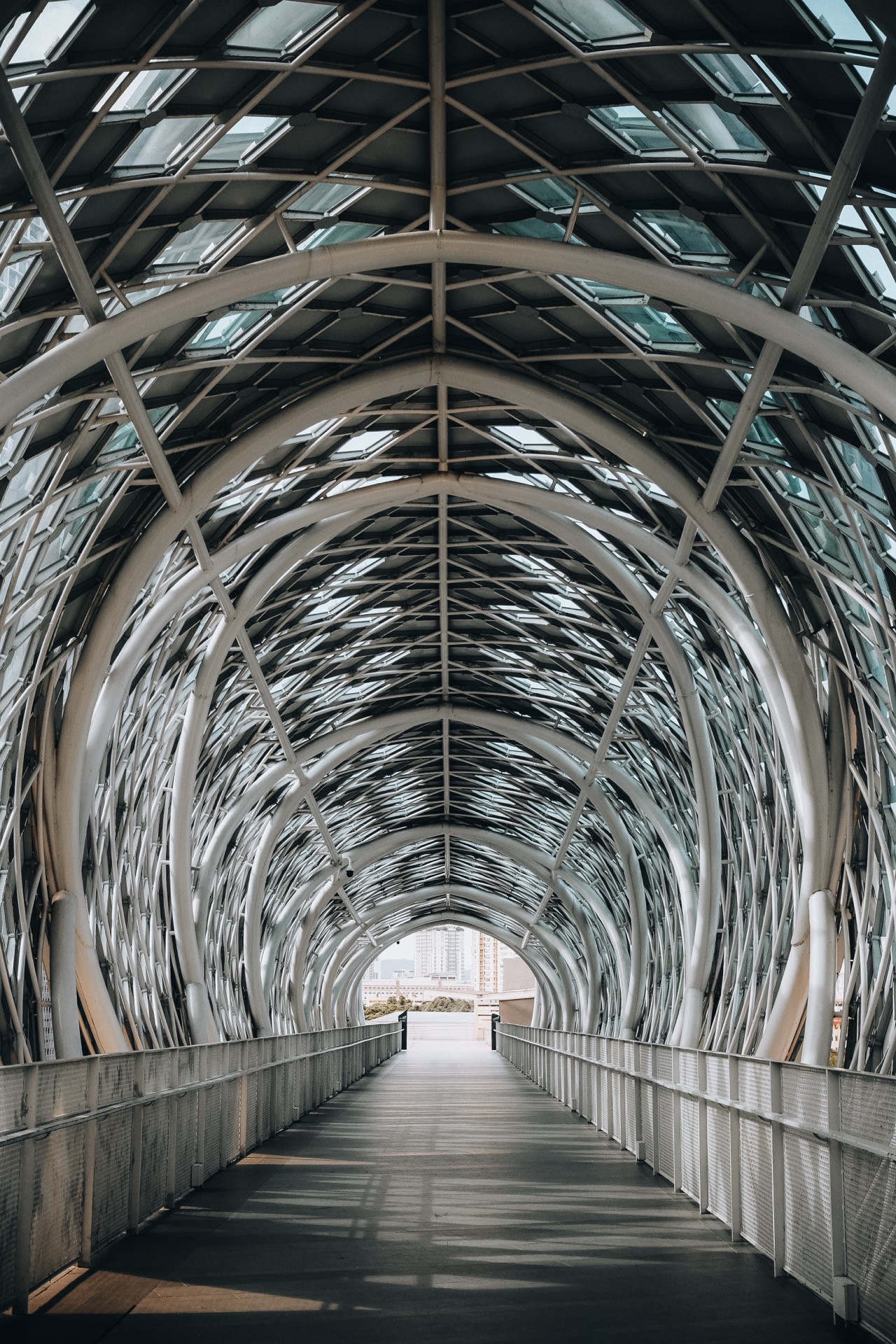 Modern steel arch pedestrian bridge in Kuala Lumpur